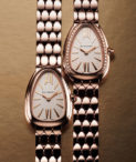 two Serpenti Seduttori watches side by side with textured background