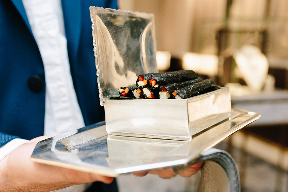 Nori 'cigarettes' with chicken and wasabi butlered in silver cigarette boxes, by Peter Callahan Catering