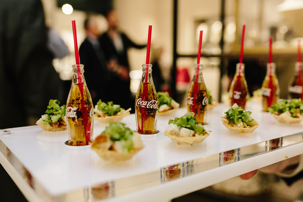 Fried chicken canapÃ© with green tomato salsa, served with rum + Coke in mini Coca Cola bottle, by Peter Callahan Catering